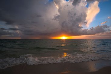 Rainstorm clouds over rough sea waters. Evening ocean...