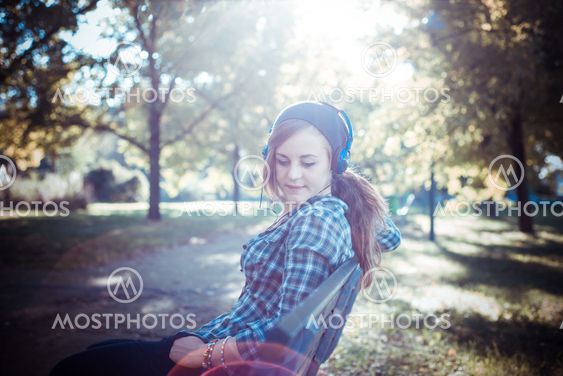 beautiful young blonde hipster woman listening music