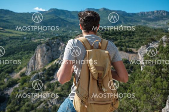 Tourist with backpack enjoy valley view from top of a...