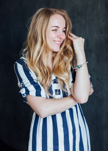 Beautiful fashionable woman in summer striped dress smiling