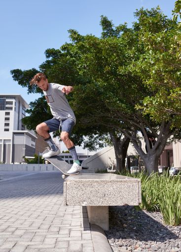 Man, jump and challenge with skateboard in city for...