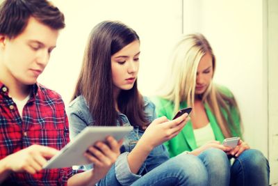 students looking into devices at school