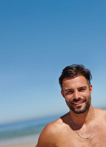 Portrait, beach and man with blue sky, vacation and...