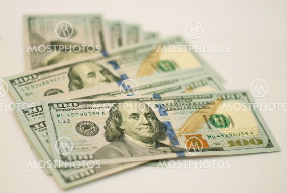 Stacks of paper 100 dollars USA on the white background