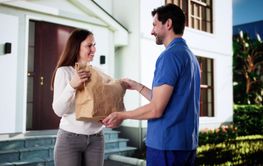 Smiling Delivery Man Hands Large Bag