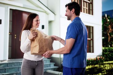 Smiling Delivery Man Hands Large Bag
