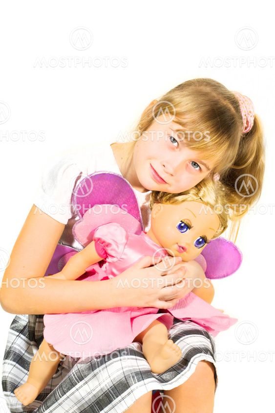 Beautiful little girl playing with a doll.
