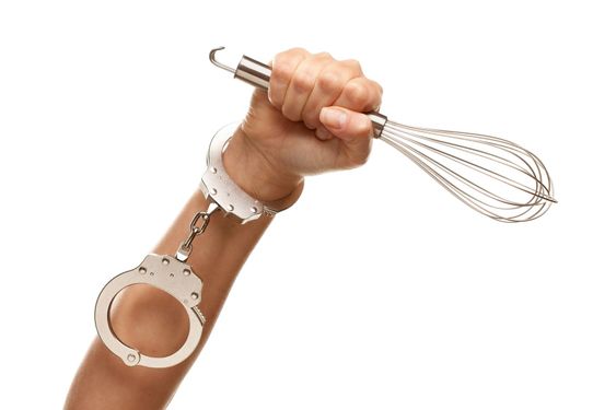 Handcuffed Woman Holding Egg Beater in Air on White