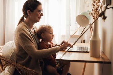 Woman working at home with her baby