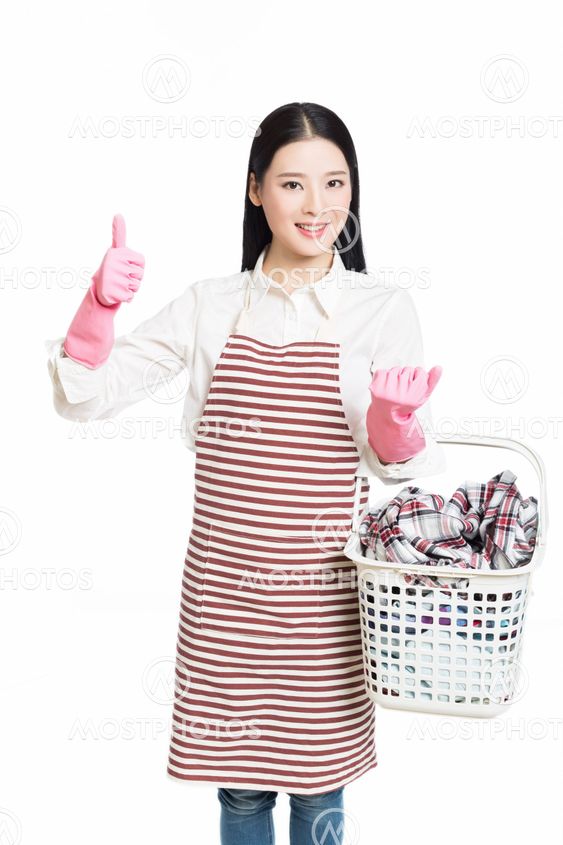 woman doing a housework holding basket of laundry