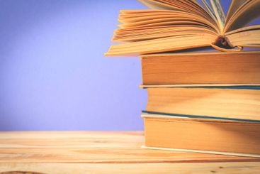 Vintage old books on wooden deck table