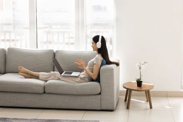 Woman using laptop lead on-line conversation by work or...