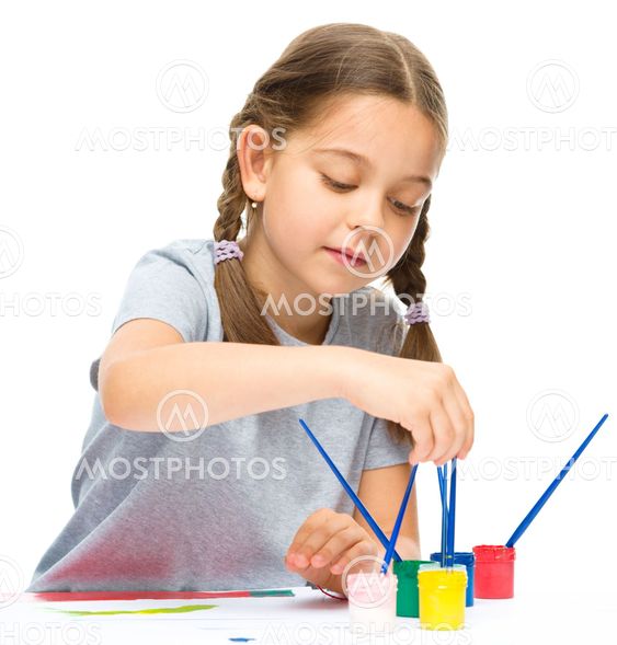 Little girl is painting with gouache