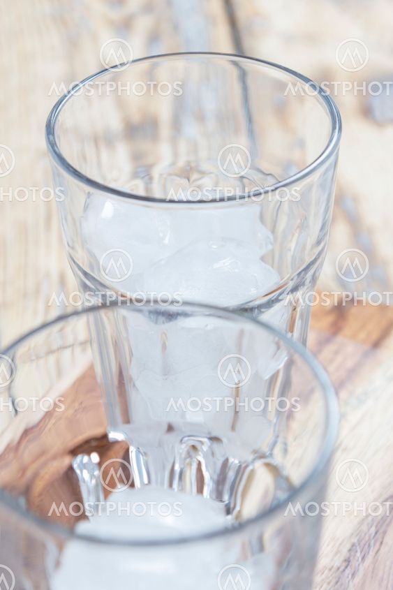 Two glasses with ice cubes