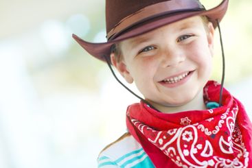 Happy, cowboy or kid in portrait in home, childhood and...