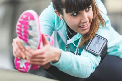 Young Woman Doing Stretching Exercises before Jogging....