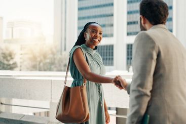 Meeting, smile and handshake with business people in...