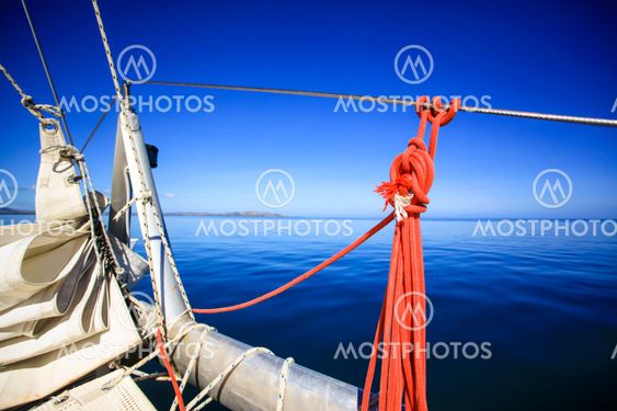 Bow of a sailing boat in calm blue sea