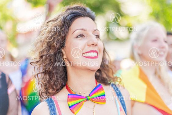 Happy brownhaired woman during the pride parade in...