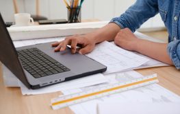 Architect and engineer working on a laptop in a...