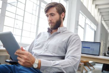 Man, typing and professional with tablet at agency,...