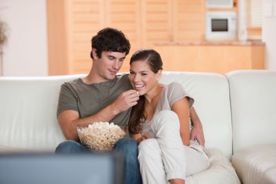 Couple on the couch watching a movie together