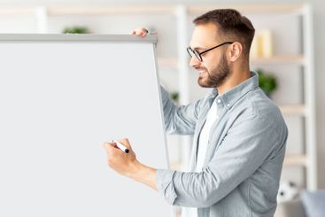 Young Caucasian male teacher giving online class,...