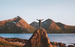 Travel in Norway outdoor man raised arms active healthy life