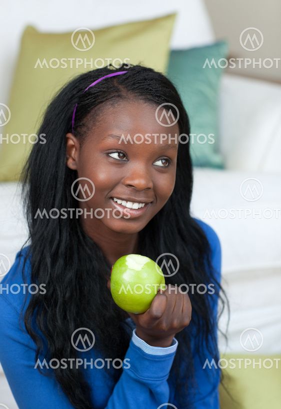 Cheerful woman eating an apple