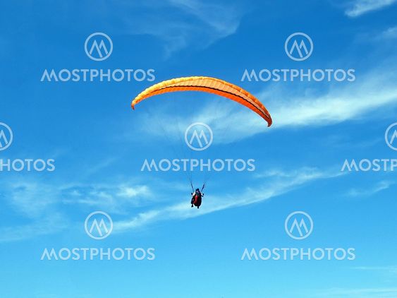 paraglider on a blue sky