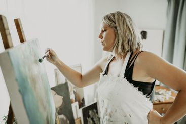 Canvas, art and woman painting in studio for creative...