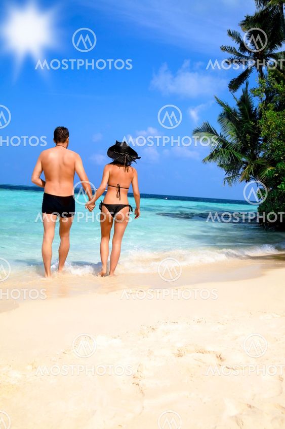 Loving couple walking on a tropical beach