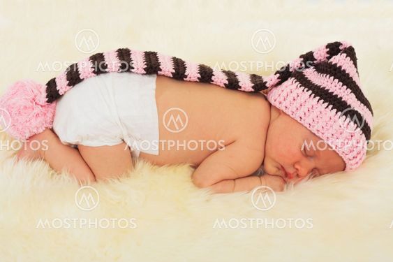 infant sleeping in the white sheep's clothing.