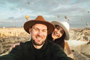 Couple of travelers having fun taking selfie watch hot...