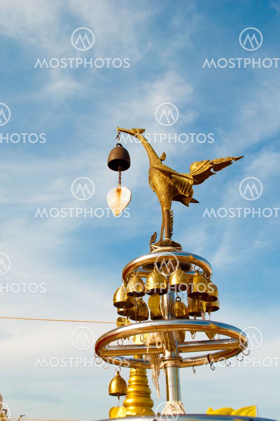 The statue golden swan hold bell in the mouth