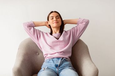 Young Caucasian woman in casual wear relaxing in...