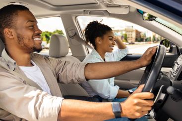 Cheerful Spouses Driving Car Travelling On Summer Vacation