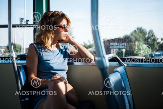 Young woman riding a public bus