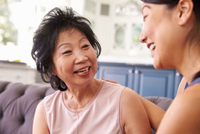 Adult Daughter Talking To Mother At Home
