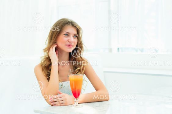 Portrait of a cute woman in a city cafe