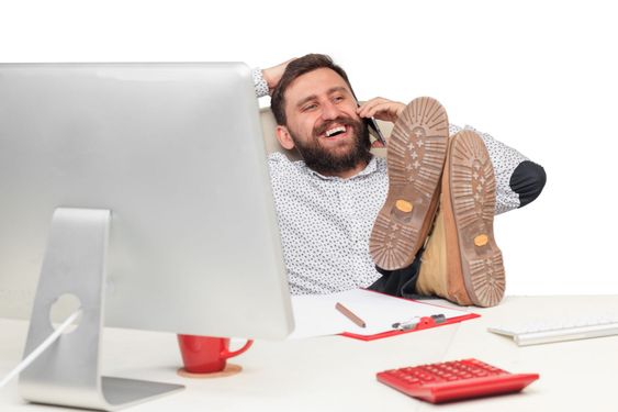 Portrait of businessman talking on mobile phone in office