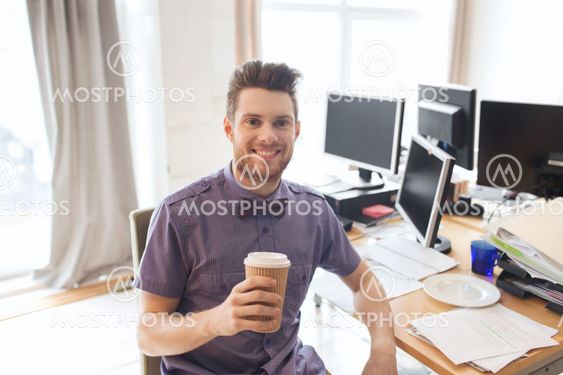 happy creative male office worker drinking coffee