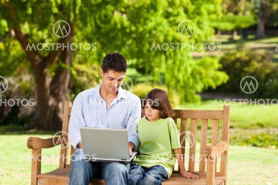 Son with his father looking at their laptop