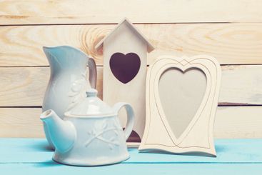 Cozy pastel wooden home decor objects on blue background