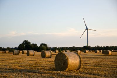 Renewable energy symbolized by straw bales and a windmill