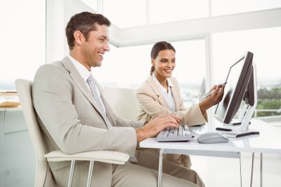 Business people using computer in office