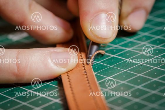 A person working as an artisan in his leather workshop...