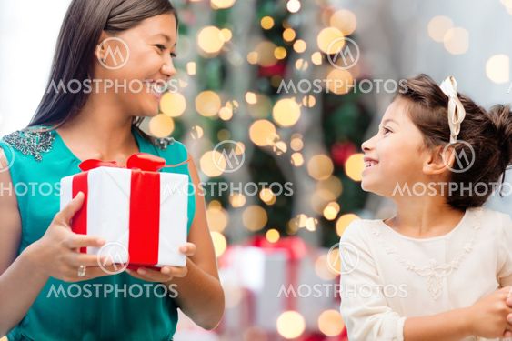 happy mother and little girl with gift box
