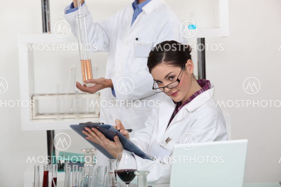 Woman taking notes in her lab.