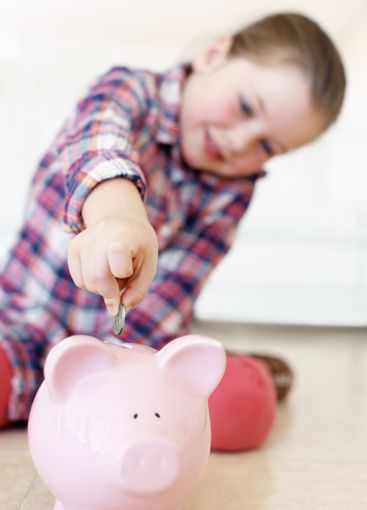 Home, child and money in piggy bank for saving,...
